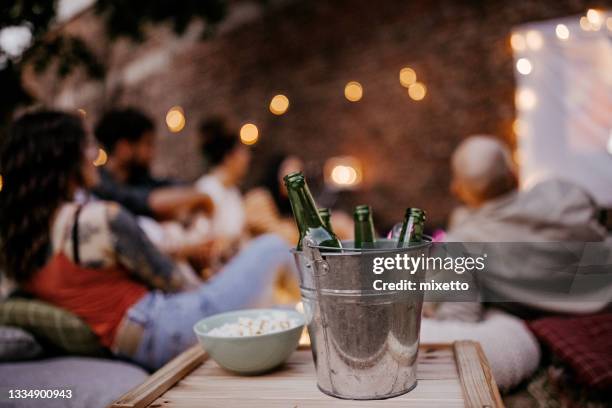 beer bottle in bucket of ice - outside cinema stockfoto's en -beelden