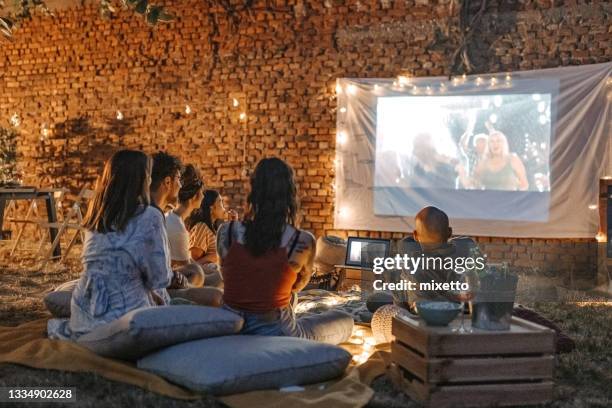 watching our favourite movie - projectieapparatuur stockfoto's en -beelden