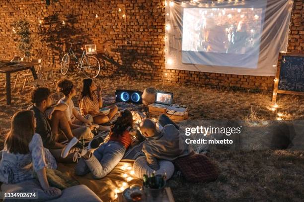 watching our favourite movie - backyard movie stock pictures, royalty-free photos & images