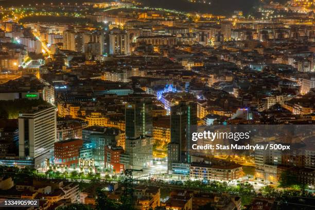 high angle view of illuminated city buildings at night,bilbao,biscay,spain - vizcaya province stock pictures, royalty-free photos & images