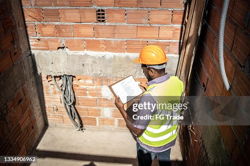 Construction worker analyzing information working in a construction site Construction worker analyzing information working in a construction site