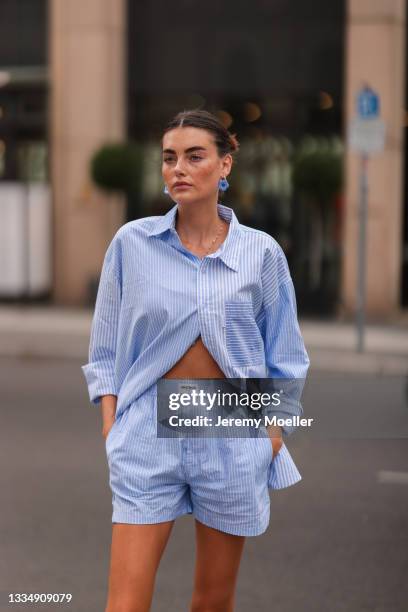 Celine Bethmann wearing blue striped Worst Behavior two piece on August 16, 2021 in Berlin, Germany.