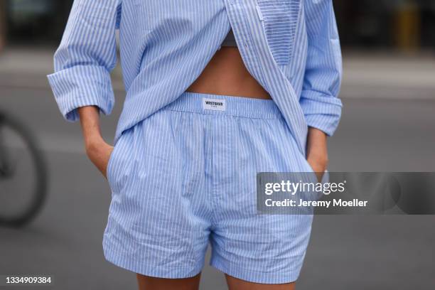 Celine Bethmann wearing blue striped Worst Behavior two piece on August 16, 2021 in Berlin, Germany.