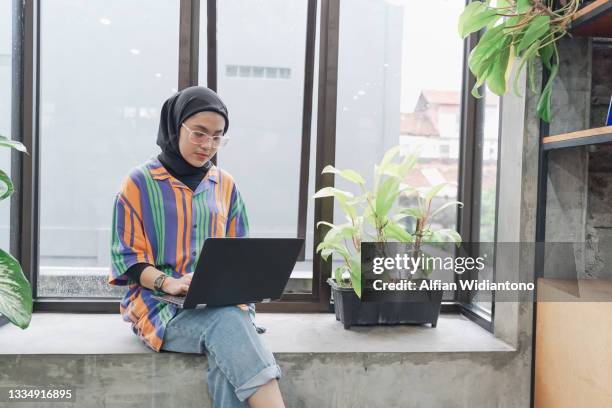 smart asian muslim young woman - malay hijab stock pictures, royalty-free photos & images