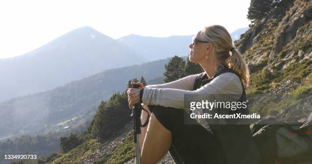 female hiker relaxes on sunny mountain ridge - andorra stock pictures, royalty-free photos & images