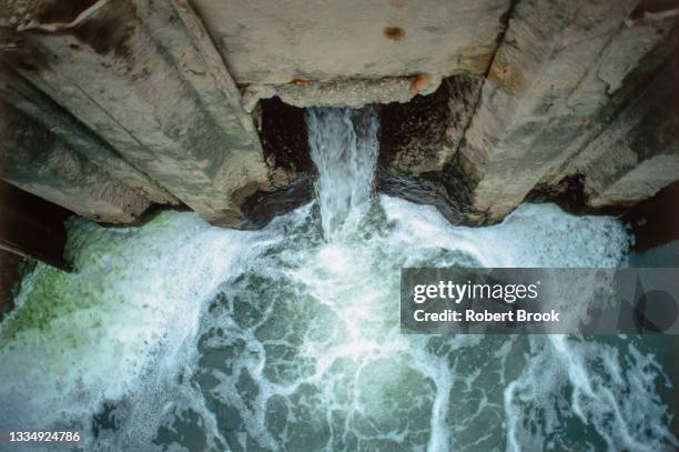 outflow of  wastewater from a pesticide plant directly into a river. - water pollution stock pictures, royalty-free photos & images