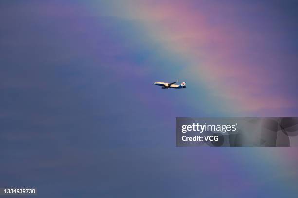 Chongqing Airlines plane flies through a rainbow on August 18, 2021 in Chongqing, China.