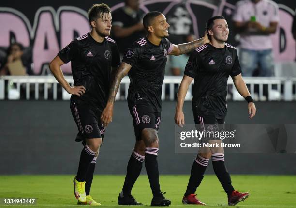 Indiana Vassilev of Inter Miami CF celebrates with teammates Gregore and Lewis Morgan after scoring a goal against Chicago Fire FC during the first...