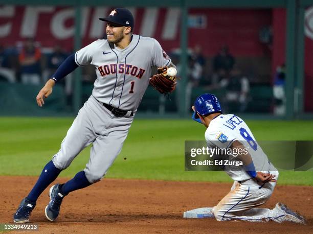 Nicky Lopez of the Kansas City Royals slides into second for a steal past Carlos Correa of the Houston Astros in the sixth inning at Kauffman Stadium...