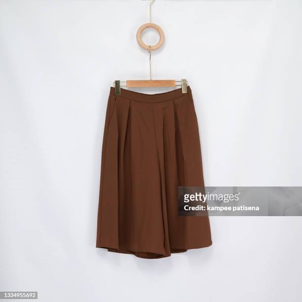 long brown skirt on white background pattern - brown suit foto e immagini stock