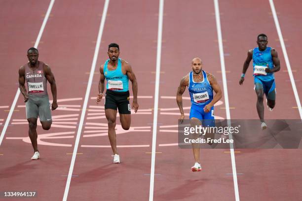 Lamont Marcell Jacobs of Italy and Zhenye Xie of Team China compete in the Men's 100m Round 1 heats on day eight of the Tokyo 2020 Olympic Games at...
