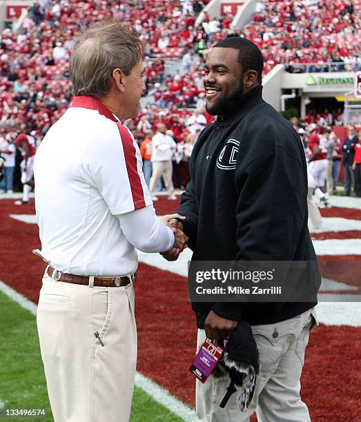 Head coach Nick Saban of the Alabama Crimson Tide shakes hands with former Alabama running back, Heisman Trophy winner and New Orleans Saints running...