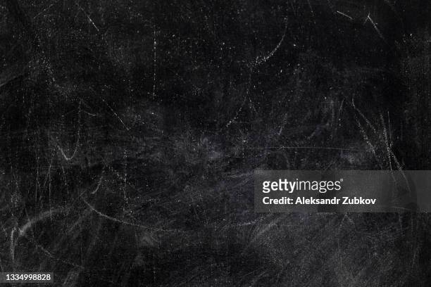 an empty black blackboard with traces and streaks of chalk. textured background. copy the space. the concept of development and education. - chalk board texture stock pictures, royalty-free photos & images