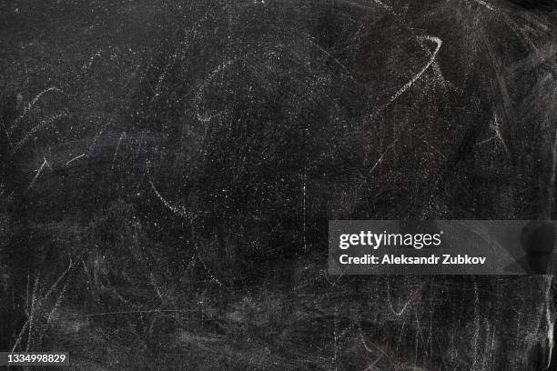 an empty black blackboard with traces and streaks of chalk. textured background. copy the space. the concept of development and education. - fond usé photos et images de collection