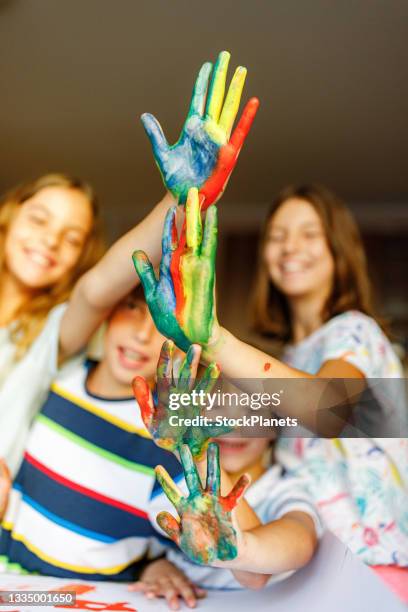 children showing colored hands - 4 girls finger painting bildbanksfoton och bilder
