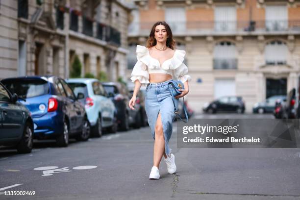 Ketevan Giorgadze @katie.one wears pearl earrings from Christian Dior, a gold chain choker CD buckle necklace from Christian Dior, a white ruffled /...