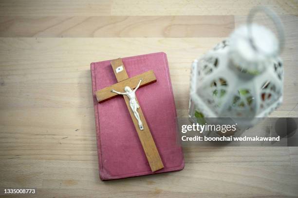 bible and cross on desk. - bible cover stock pictures, royalty-free photos & images