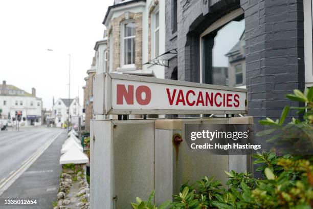 Bed and breakfast displays a No Vacancies sign on August 19, 2021 in Newquay, Cornwall, England. At a time when summer holiday-makers flood into the...