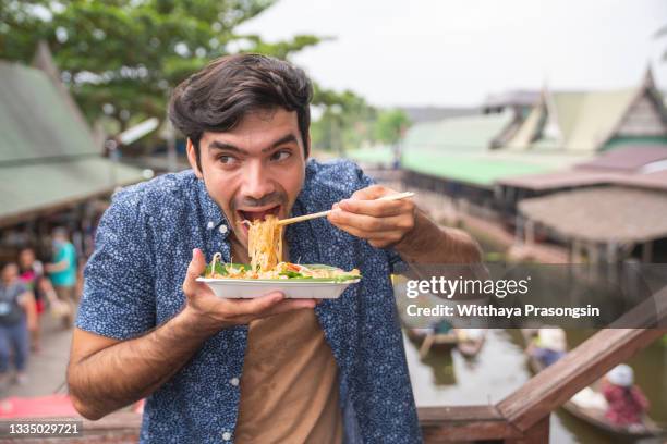 tourist eating pad thai noodle - pad thai stock pictures, royalty-free photos & images