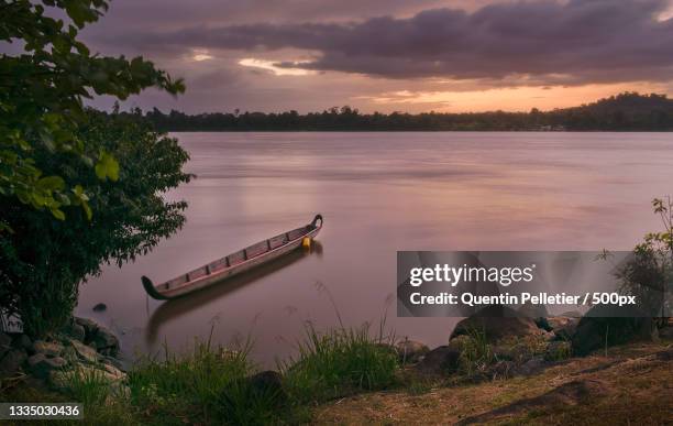 scenic view of lake against sky during sunset,apatou,saint laurent du maroni,french guiana - french guiana stock-fotos und bilder