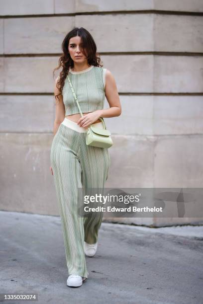 Ketevan Giorgadze @katie.one wears a white and green striped / ribbed comfortable knitted green cropped t-shirt from Le Ger, matching white and green...