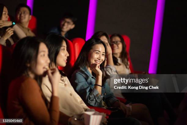 group of people enjoying watching movie at movie theater. - asian cinema stock pictures, royalty-free photos & images