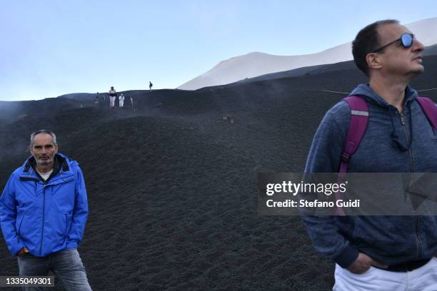 Tourists visiting the Etna Volcano on August 19, 2021 in Etna, near Catania, Italy. Etna is a volcano from Sicily originating in quaternary, and is...