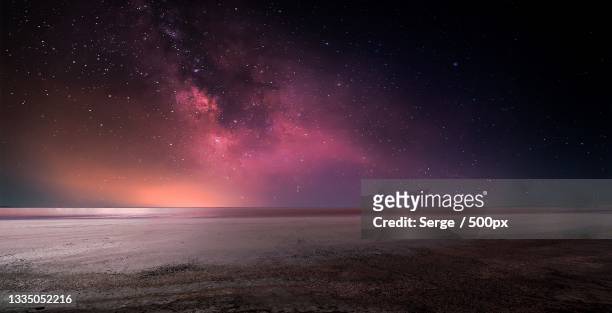 scenic view of sea against sky at night - planet space foto e immagini stock