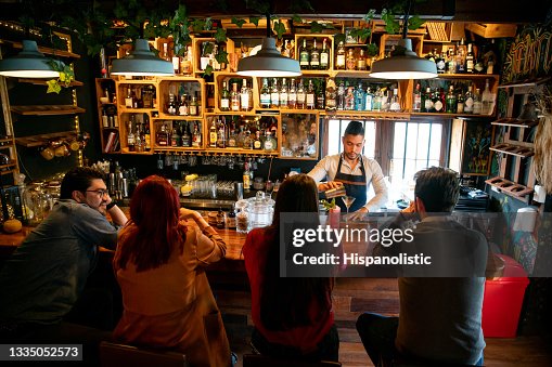 Bartender at the bar making cocktails for people Bartender at the bar making cocktails for people