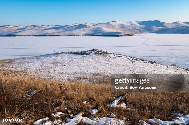 winter landscape of lake baikal covering by snow view from the small hill. - snow on grass imagens e fotografias de stock