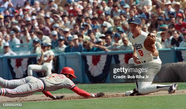 St. Louis Cardinal Ozzie Smith dives back to first base in pickoff attempt with 1st baseman Greg Brock during playoff series of the Los Angeles...