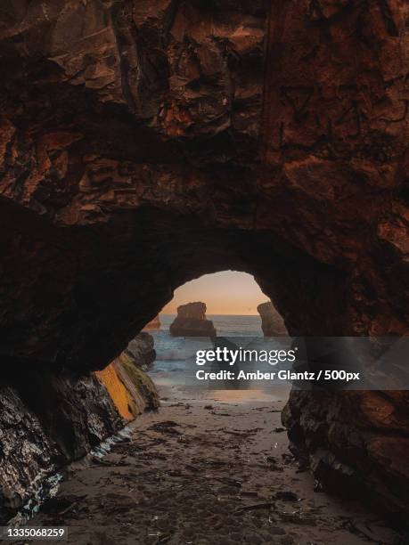 scenic view of sea seen through cave,santa cruz,california,united states,usa - santa cruz california beach stock pictures, royalty-free photos & images