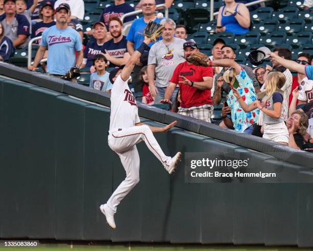 Max Kepler of the Minnesota Twins fields and makes a catch at the wall against the Cleveland Indians on August 16, 2021 at Target Field in...