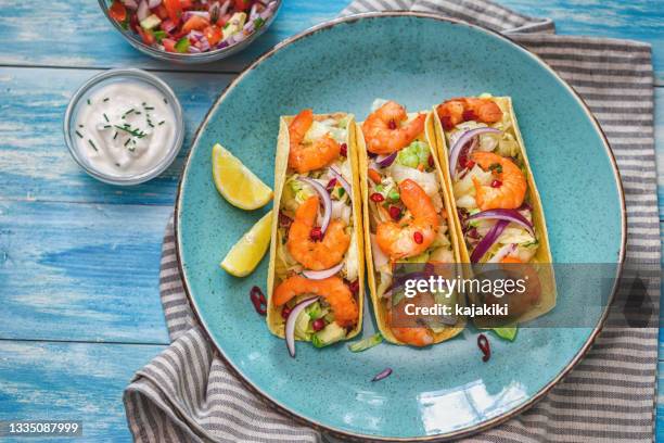 homemade shrimp tacos with spicy avocado salad - home made tacos stock pictures, royalty-free photos & images