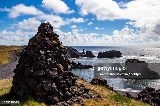 scenic view of rocks on beach against sky - landslag imagens e fotografias de stock