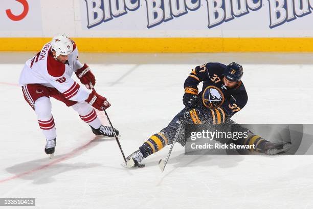 Boyd Gordon of the Phoenix Coyotes and Matt Ellis of the Buffalo Sabres work for control of the puck at First Niagara Center on November 19, 2011 in...