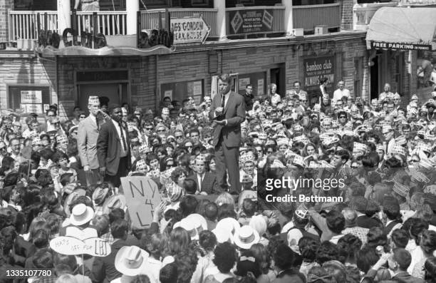 Attorney General Robert Kennedy is surrounded by admiring crowds as he delivers an impromptu speech on an Atlantic City street.