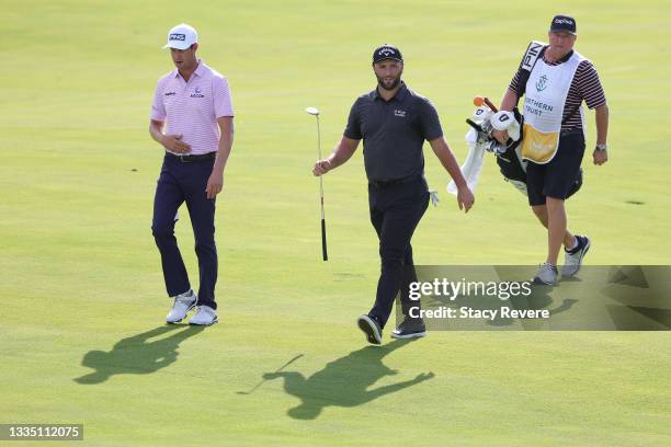 Harris English of the United States, Jon Rahm of Spain and caddie Eric Larson walk the 14th hole during the first round of THE NORTHERN TRUST, the...