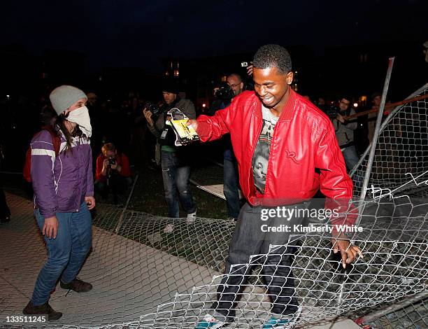 Demonstrators stomp on a chain link fence they pulled down November 19, 2011 in Oakland, California. Occupy Oakland protesters, calling for a "mass...