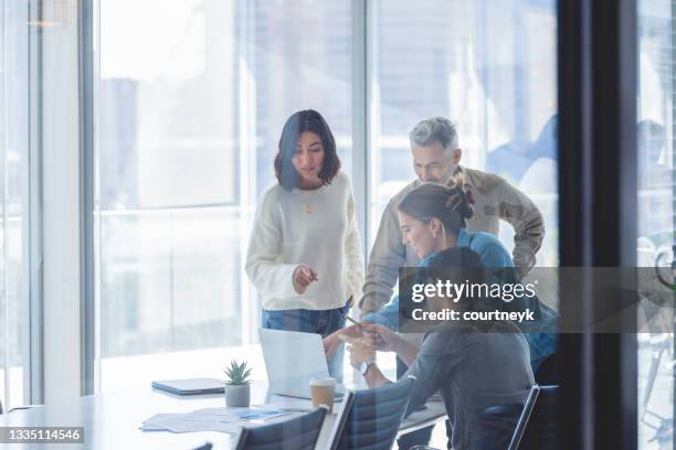 group of business people working. - four people business talking stock pictures, royalty-free photos & images