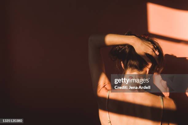love, relationships and loneliness: woman back view with heart tattoo on neck - woman back tattoo stock pictures, royalty-free photos & images