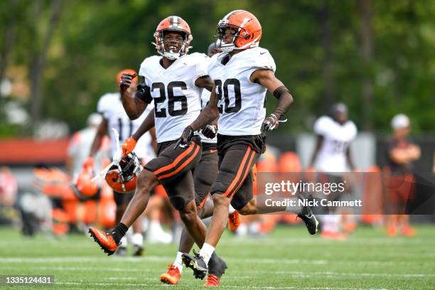 Greedy Williams and Greg Newsome II of the Cleveland Browns celebrate an interception by Newsome during a joint practice with the New York Giants on...