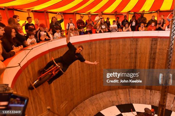 Rider performs on the Wall of Death at the British Motor Show at Farnborough International, Exhibition and Conference Centre on August 19, 2021 in...