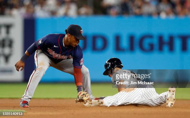 Jorge Polanco of the Minnesota Twins is late with the tag as Andrew Velazquez of the New York Yankees steals second base in the fourth inning at...