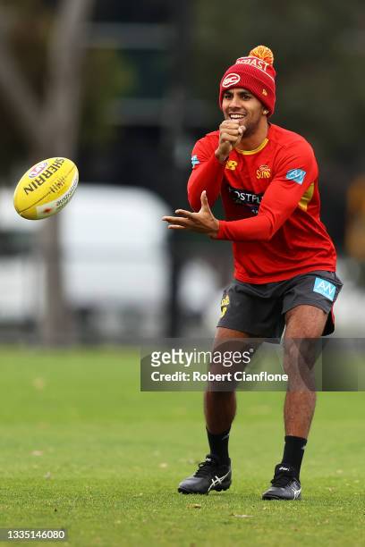 Touk Miller passes during a Gold Coast Suns AFL training session at Gosch's Paddock on August 20, 2021 in Melbourne, Australia.