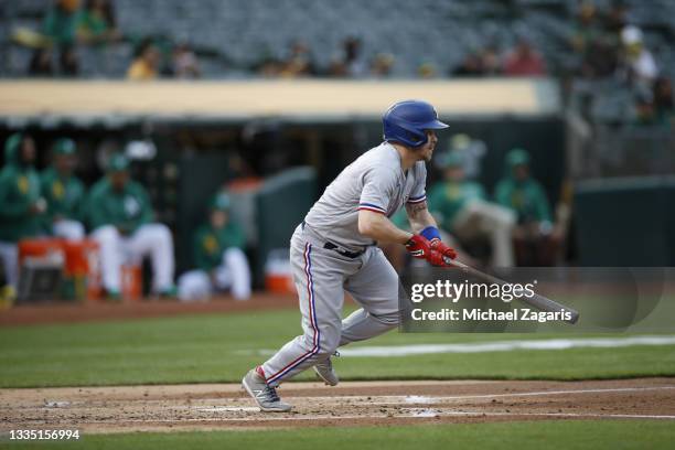 Brock Holt of the Texas Rangers bats during the game against the Oakland Athletics at RingCentral Coliseum on August 6, 2021 in Oakland, California....