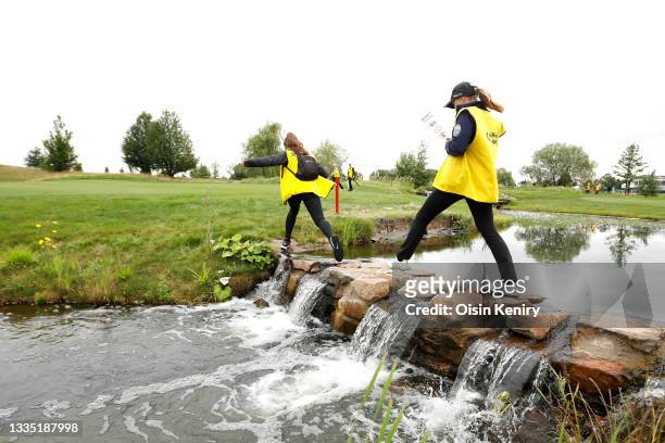 Course marshals cross the river on the 17th hole during Day Two of The D+D Real Czech Masters at Albatross Golf Resort on August 20, 2021 in Prague,...