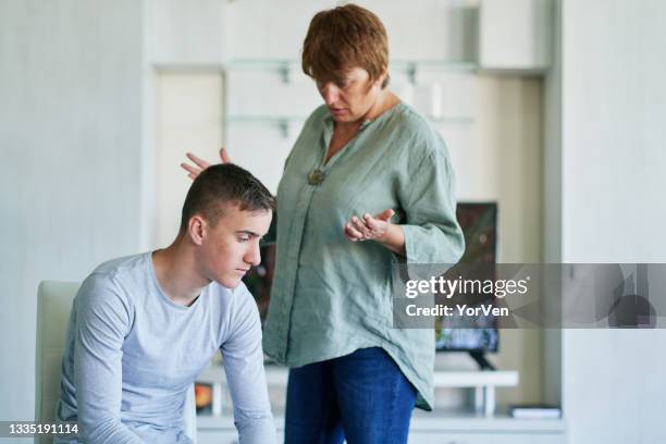 mother and her teenage son arguing at home - mom shouting stock pictures, royalty-free photos & images