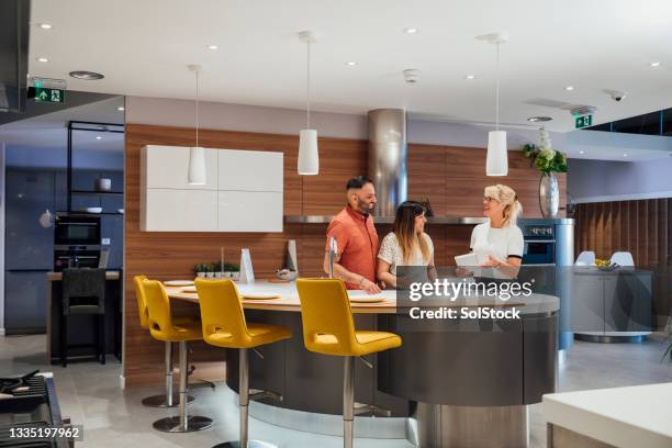 couple viewing luxury kitchens - showroom stock pictures, royalty-free photos & images