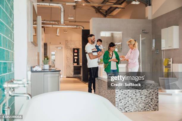 family looking at tile samples - bathroom tile showroom stock pictures, royalty-free photos & images